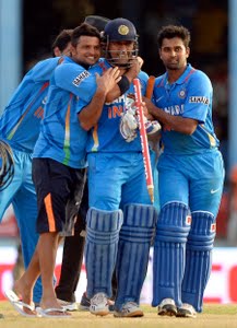 MS Dhoni is surrounded by his team-mates after lifting India to victory, India v Sri Lanka, tri-series final