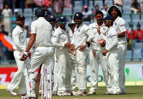 India players wait for Mitchell Johnson to leave after he was bowled.